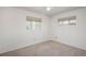 Carpeted bedroom with two windows and a neutral color scheme at 1077 Salem St, Aurora, CO 80011
