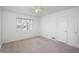 Carpeted bedroom featuring a ceiling fan and a large window showcasing the exterior at 1077 Salem St, Aurora, CO 80011