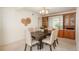 Well-lit dining room featuring a large table with six chairs and built-in cabinets at 1077 Salem St, Aurora, CO 80011