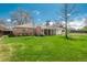 Spacious backyard view highlighting brick home with covered patio and lush greenery at 1077 Salem St, Aurora, CO 80011