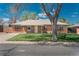 Classic brick home with a well-manicured lawn and mature trees offering shade and curb appeal at 1077 Salem St, Aurora, CO 80011