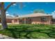 Charming brick home with a well-maintained lawn, mature trees, and an inviting facade at 1077 Salem St, Aurora, CO 80011