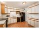 Classic kitchen featuring wood-trimmed cabinets, black appliances, and modern lighting at 1077 Salem St, Aurora, CO 80011