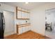 Efficient kitchen area featuring wood-trimmed cabinets and access to dining and hallway at 1077 Salem St, Aurora, CO 80011