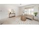 Bright living room with neutral tones, cozy seating, and a large window providing ample natural light at 1077 Salem St, Aurora, CO 80011