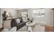 Bright living room featuring a leather couch, white ottomans, neutral colors and large windows at 1077 Salem St, Aurora, CO 80011