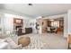 Open-concept living and dining area with modern decor, fireplace, and large windows at 1077 Salem St, Aurora, CO 80011