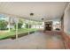 Covered patio with a brick fireplace and access to the landscaped backyard at 1077 Salem St, Aurora, CO 80011