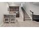 Basement featuring a wet bar with seating and staircase at 10929 Endeavor Dr, Parker, CO 80134
