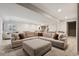 Basement living area featuring a large sectional sofa with throw pillows and an ottoman at 10929 Endeavor Dr, Parker, CO 80134