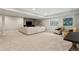 Basement living area with a large sectional sofa, chairs, and natural light from egress window at 10929 Endeavor Dr, Parker, CO 80134