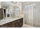 Modern bathroom with a spacious walk-in shower, granite countertop, and elegant fixtures at 10929 Endeavor Dr, Parker, CO 80134