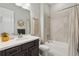 Neutral bathroom featuring a dark vanity, tiled shower, and macrame wall art at 10929 Endeavor Dr, Parker, CO 80134