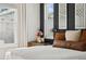 Cozy bedroom featuring a bright window, bedside table with decor, and stylish design elements at 10929 Endeavor Dr, Parker, CO 80134