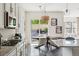 Eat-in kitchen with a dark wood table, wicker chandelier, stainless appliances, and backyard view at 10929 Endeavor Dr, Parker, CO 80134