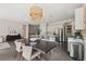 Open-concept dining area with an oversized table, stylish light fixtures, and seamless flow into the kitchen at 10929 Endeavor Dr, Parker, CO 80134