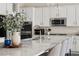 Bright kitchen with white cabinets, stainless steel appliances, and a large island with granite countertops at 10929 Endeavor Dr, Parker, CO 80134