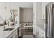 Modern kitchen with white cabinets, granite countertops, stainless steel appliances, and access to the upper level at 10929 Endeavor Dr, Parker, CO 80134