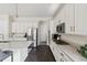 Spacious kitchen with white cabinetry, stainless steel appliances, granite countertops and dark wood flooring at 10929 Endeavor Dr, Parker, CO 80134