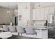 Bright kitchen featuring a spacious island with seating, granite countertops, and stainless steel appliances at 10929 Endeavor Dr, Parker, CO 80134