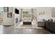 Inviting living room featuring a fireplace, large windows, and stylish neutral furnishings with hardwood floors at 10929 Endeavor Dr, Parker, CO 80134