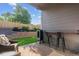 This outdoor patio includes a small bar area and grill with views of the landscaped backyard at 10929 Endeavor Dr, Parker, CO 80134