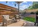 This outdoor patio is fenced, has seating, and has a view of the landscaped backyard at 10929 Endeavor Dr, Parker, CO 80134