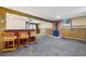 Spacious basement rec room features a retro bar area, brick fireplace and neutral colors at 12771 W 6Th Pl, Lakewood, CO 80401