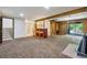 Spacious basement rec room featuring a retro bar area, fireplace and sliding glass door to the exterior at 12771 W 6Th Pl, Lakewood, CO 80401
