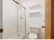 Bright bathroom featuring a glass-enclosed shower with white subway tile surround and neutral fixtures at 12771 W 6Th Pl, Lakewood, CO 80401