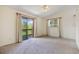 Bright bedroom with an outdoor deck, neutral carpet, and ample natural light from a large window at 12771 W 6Th Pl, Lakewood, CO 80401