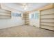 Neutral carpeted bedroom with recessed lighting, ceiling fan, built in shelves and windows at 12771 W 6Th Pl, Lakewood, CO 80401