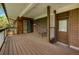Spacious outdoor deck features wood flooring, brick siding, and a sliding glass door leading inside the home at 12771 W 6Th Pl, Lakewood, CO 80401
