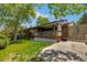 Charming home with a covered deck, lush green lawn, and mature trees enhancing its curb appeal at 12771 W 6Th Pl, Lakewood, CO 80401