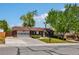 Charming brick home with attached two-car garage and well-manicured front lawn under a clear blue sky at 12771 W 6Th Pl, Lakewood, CO 80401