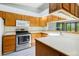 Bright kitchen featuring white countertops, stainless steel appliances, and classic wood cabinetry at 12771 W 6Th Pl, Lakewood, CO 80401