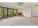 Spacious living room with a stone fireplace and large windows overlooking the outdoor greenery at 12771 W 6Th Pl, Lakewood, CO 80401