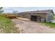 Large backyard with a patio, wooden deck, storage, and grass area at 40192 Margaret Dr, Elizabeth, CO 80107
