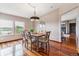Elegant dining room with hardwood floors, a modern chandelier, and picturesque views at 40192 Margaret Dr, Elizabeth, CO 80107