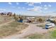 Exterior home with barn, red house, RV, and hillside landscape at 40192 Margaret Dr, Elizabeth, CO 80107