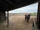 View of horses under a covered shelter on a property with fenced pastures at 40192 Margaret Dr, Elizabeth, CO 80107