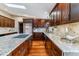 Well-appointed kitchen with a central island, granite countertops, dark wood cabinets, and hardwood floors at 40192 Margaret Dr, Elizabeth, CO 80107