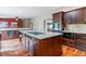 Beautiful kitchen with granite countertops, dark wood cabinets, a central island, and hardwood floors at 40192 Margaret Dr, Elizabeth, CO 80107