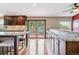 Bright kitchen featuring granite countertops, dark wood cabinets, hardwood floors and an exterior access door at 40192 Margaret Dr, Elizabeth, CO 80107