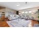 Inviting living room featuring a plush sofa, chairs, bay window, hardwood floors and stylish decor at 40192 Margaret Dr, Elizabeth, CO 80107