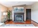 Charming living room with a fireplace, hardwood floors, tasteful decor, and a neutral color palette at 40192 Margaret Dr, Elizabeth, CO 80107