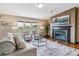 Cozy living room showcasing a fireplace, comfortable seating, a bay window and hardwood floors at 40192 Margaret Dr, Elizabeth, CO 80107