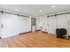Living space with hardwood floors, wood stove, barn doors, and white walls at 40192 Margaret Dr, Elizabeth, CO 80107