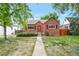 Charming brick home with well-maintained front lawn and inviting walkway at 1335 Locust St, Denver, CO 80220