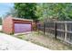 Detached garage with an adjacent fenced yard at 1335 Locust St, Denver, CO 80220